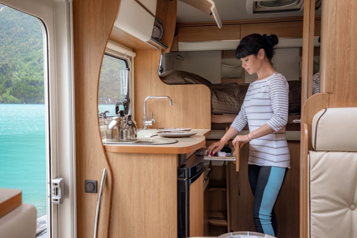 Woman Cooking inside RV Van