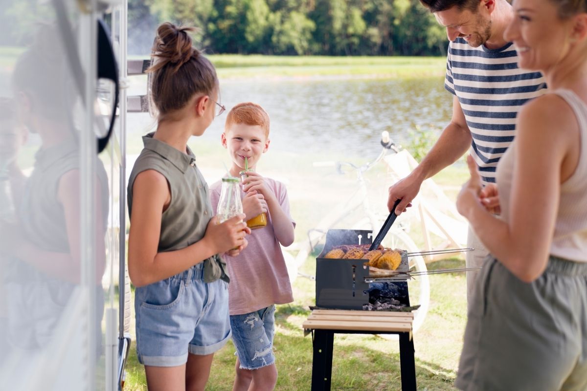 Family Grilling Outside the Campsite