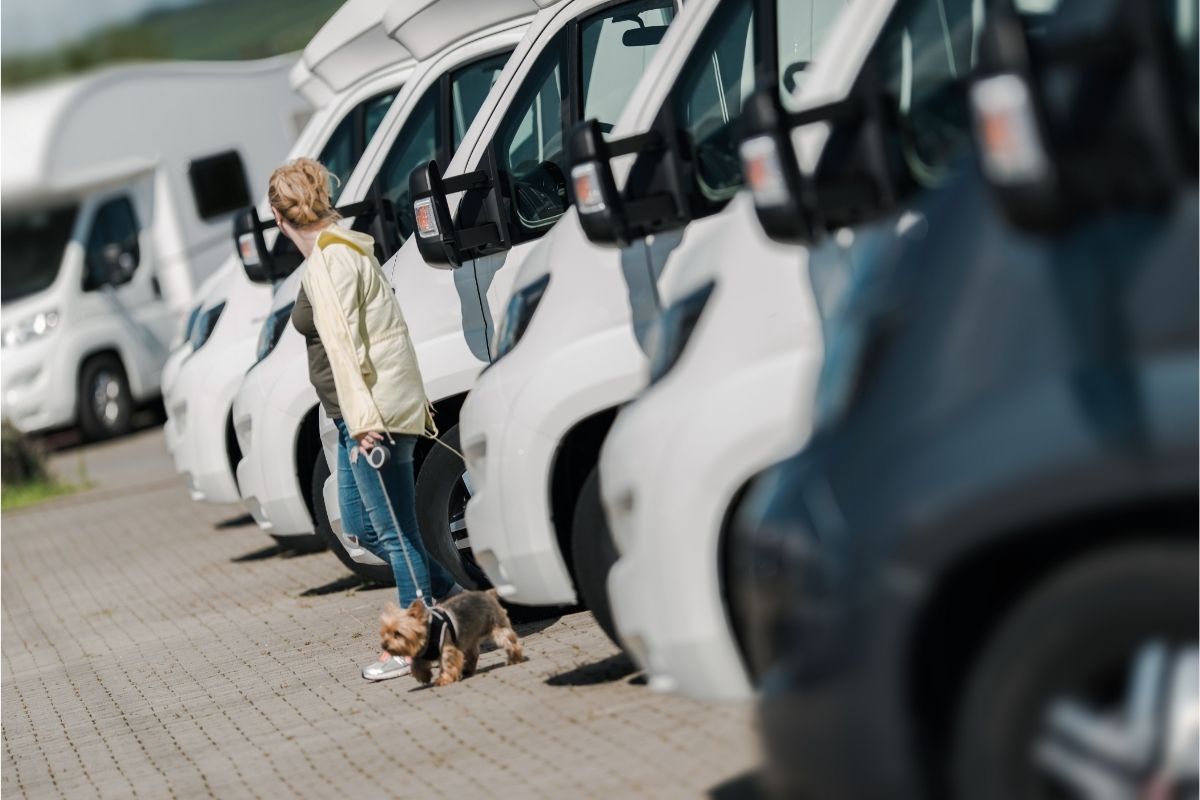 Woman with a Puppy Buying New Camper Van