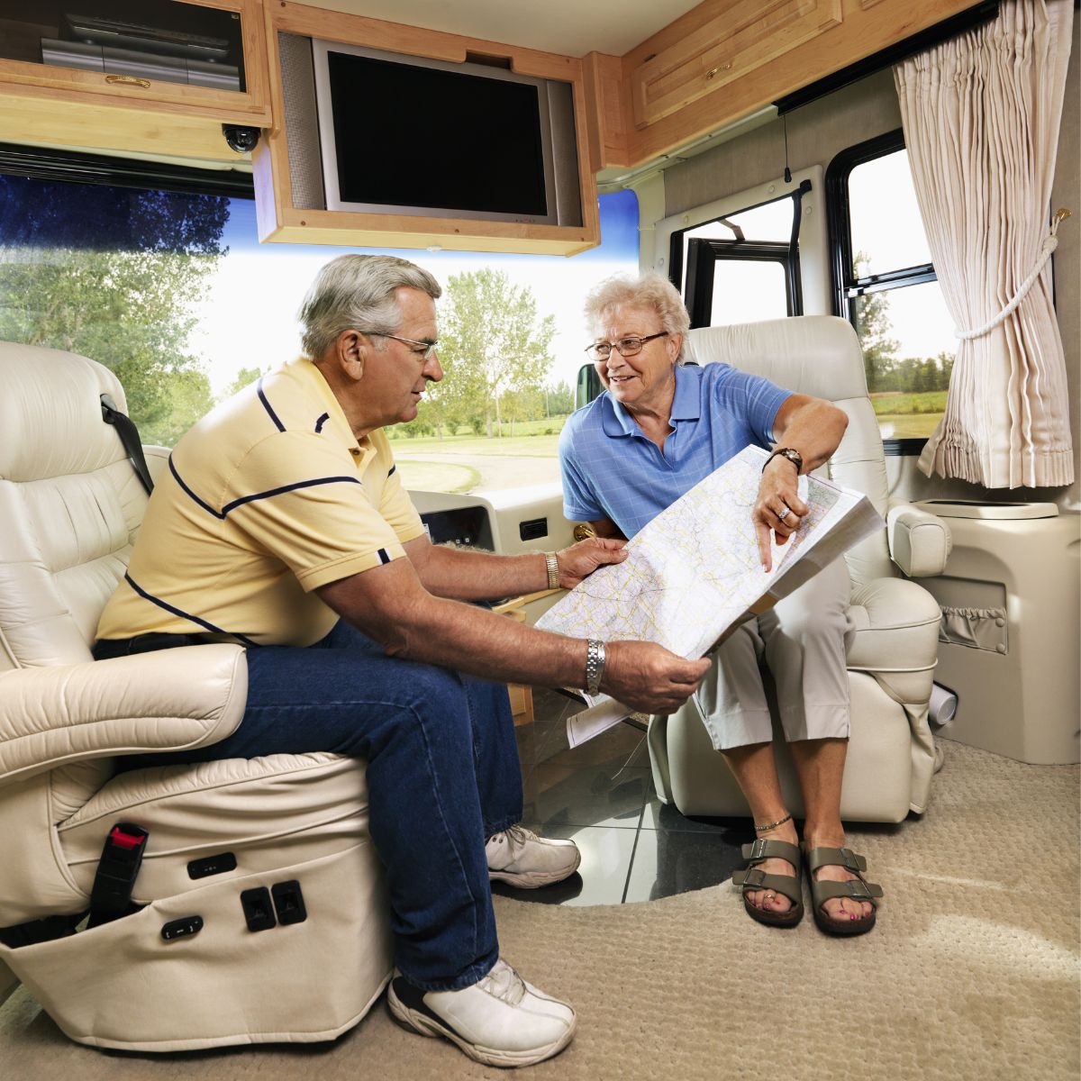 senior couple in a rv with tv
